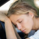 tired woman asleep at drivers wheel a drowsy driver